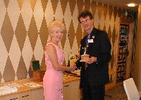 Mrs Pat Morcom presents the new Bill Morcom Trophy to the Club, in memory of her late husband. Keith Levin receives the trophy on behalf of the Club.